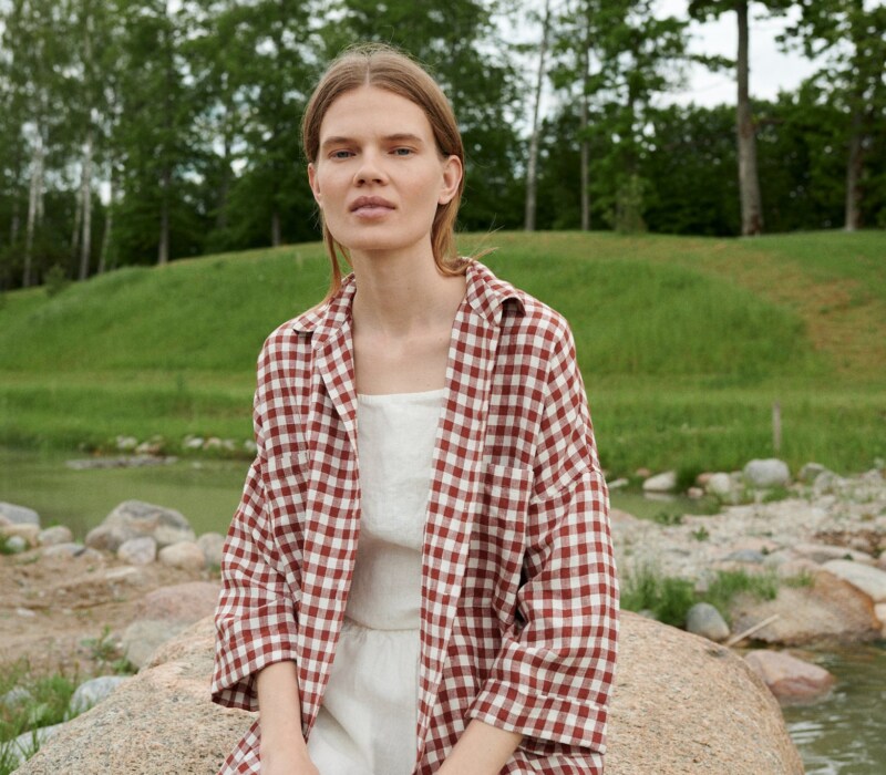 A model in brown gingham oversized linen shirt