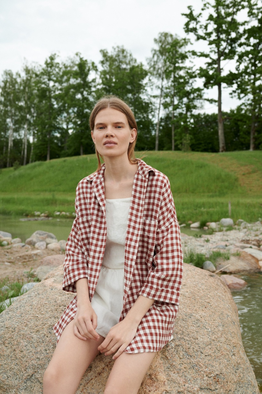 A model in brown gingham oversized linen shirt