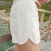 White linen shorts with curved hem and side slits