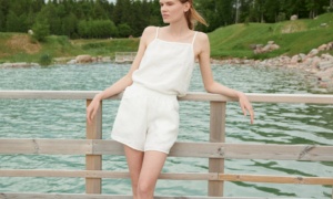 Model in a white linen summer top and matching linen shorts