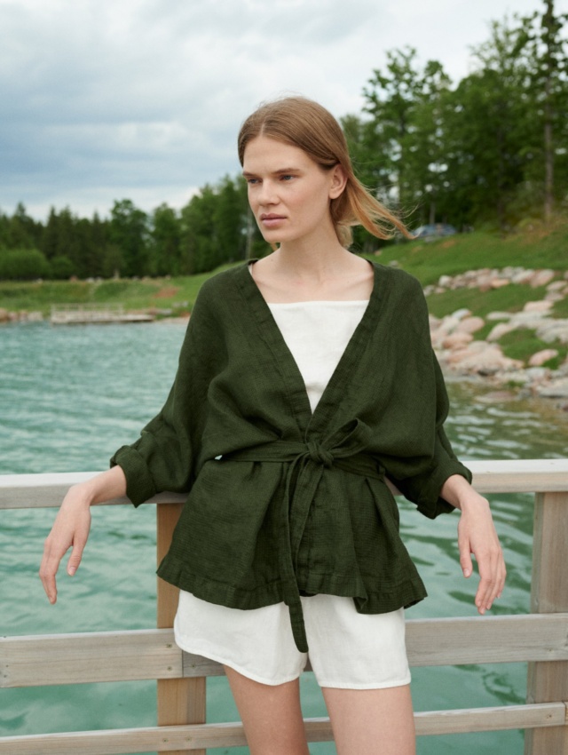 Woman wearing an oversized waffle linen jacket paired with a white linen summer top and shorts