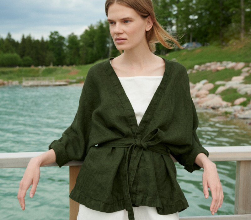 Woman wearing an oversized waffle linen jacket paired with a white linen summer top and shorts