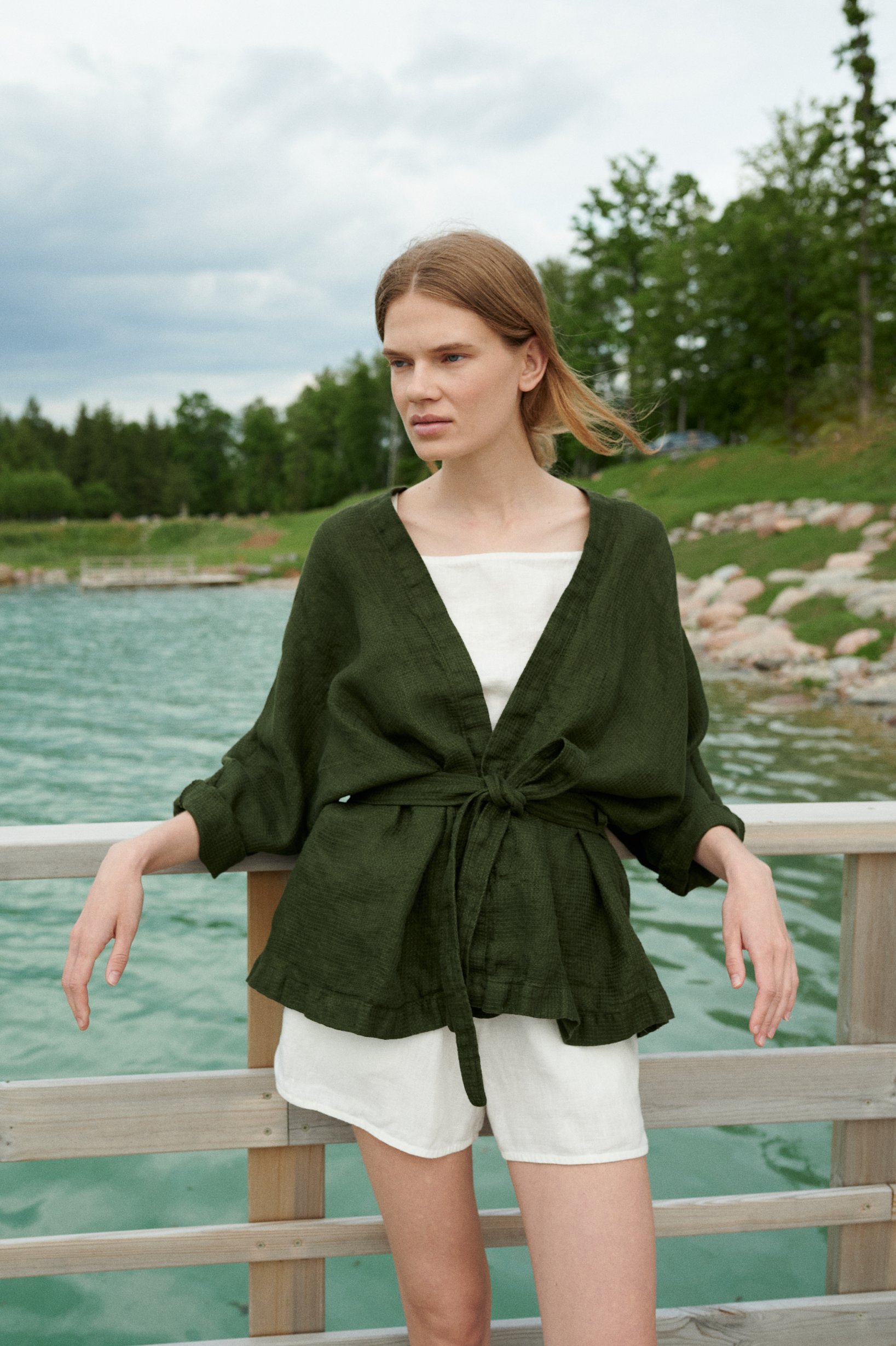 Woman wearing an oversized waffle linen jacket paired with a white linen summer top and shorts