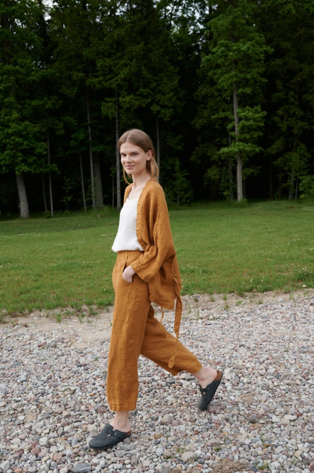 Linenfox model wearing dark yellow wide leg waffle linen pants