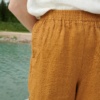 Elasticated waistband of wide leg waffle linen trousers