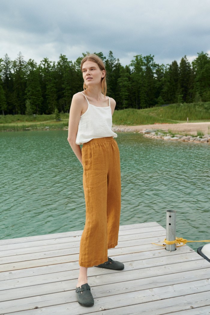 A woman in high waisted dark yellow waffle linen pants