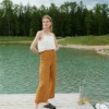 A model standing in deep yellow waffle linen trousers