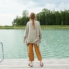 Back of a model in an oversized waffle linen jacket and cropped linen trousers