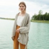 Model wearing an oversized kimono-style jacket untied paired with loose fitting linen trousers