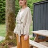 Woman in an oversized waffle linen jacket with a belt