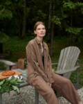 Model in a loose-fitting waffle linen button down shirt and matching linen trousers outfit