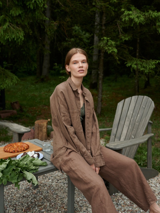 Model in a loose-fitting waffle linen button down shirt and matching linen trousers outfit