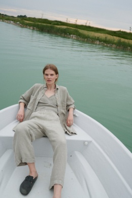 A woman in natural grey waffle linen wide leg pants