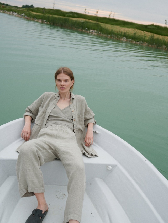 A woman in natural grey waffle linen wide leg pants