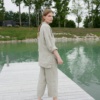 A woman wearing waffle linen wide leg trousers in natural grey