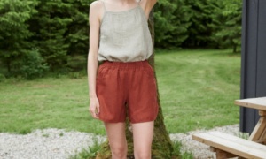 A summer linen top tucked into linen shorts with an elasticated waistband