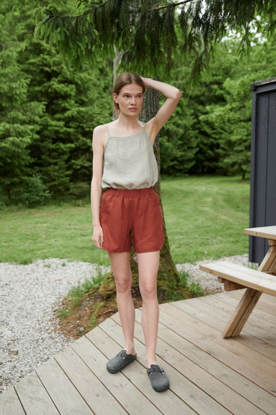 A summer linen top tucked into linen shorts with an elasticated waistband