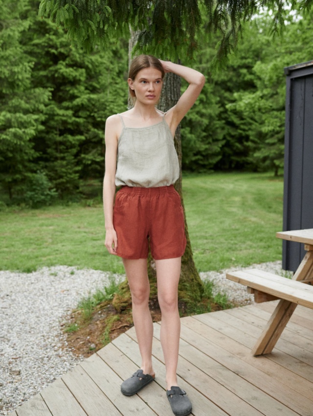 A summer linen top tucked into linen shorts with an elasticated waistband