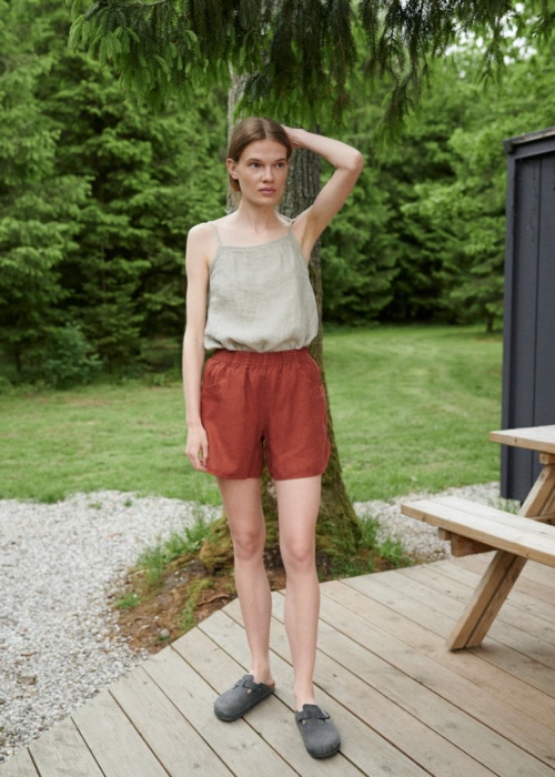 Woman wearing wide leg waffle linen shorts and a linen summer top