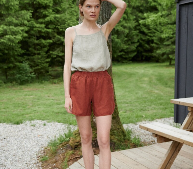 Woman wearing wide leg waffle linen shorts and a linen summer top