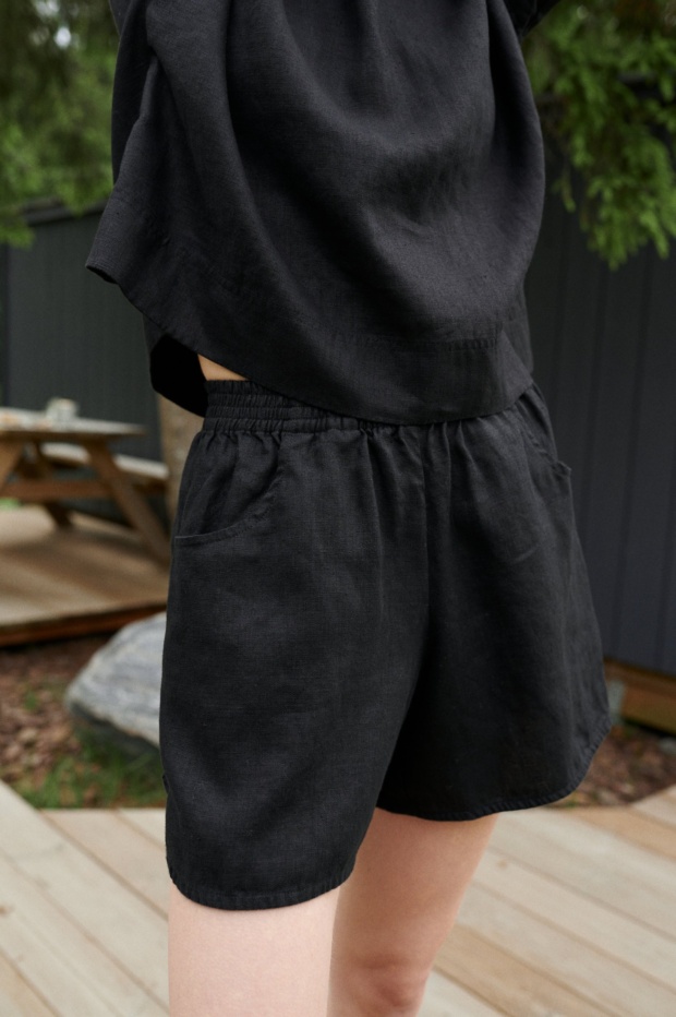 Black linen shorts with an elasticated waistband and pockets