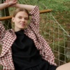 Model wearing a relaxed linen top and a terracotta gingham shirt on top