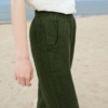 Dark green waffle linen trousers on a model