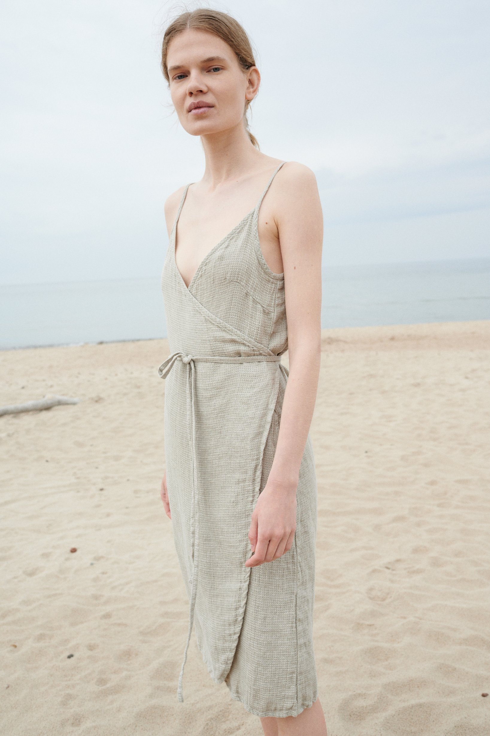Model wearing a flowy waffle linen summer dress with a matching belt