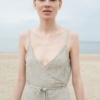 Front of a natural grey waffle linen summer dress with a deep V-neckline
