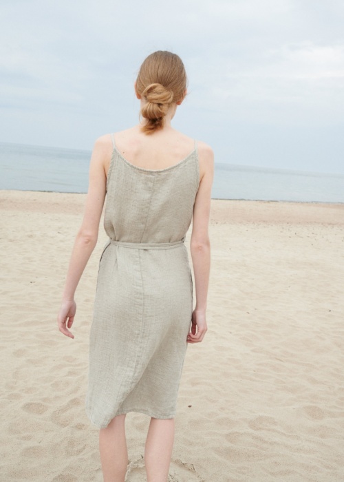 Back of a model wearing a waffle linen summer dress with thin straps