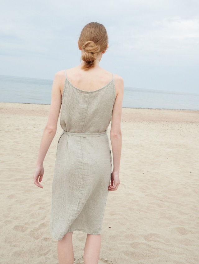 Back of a model wearing a waffle linen summer dress with thin straps