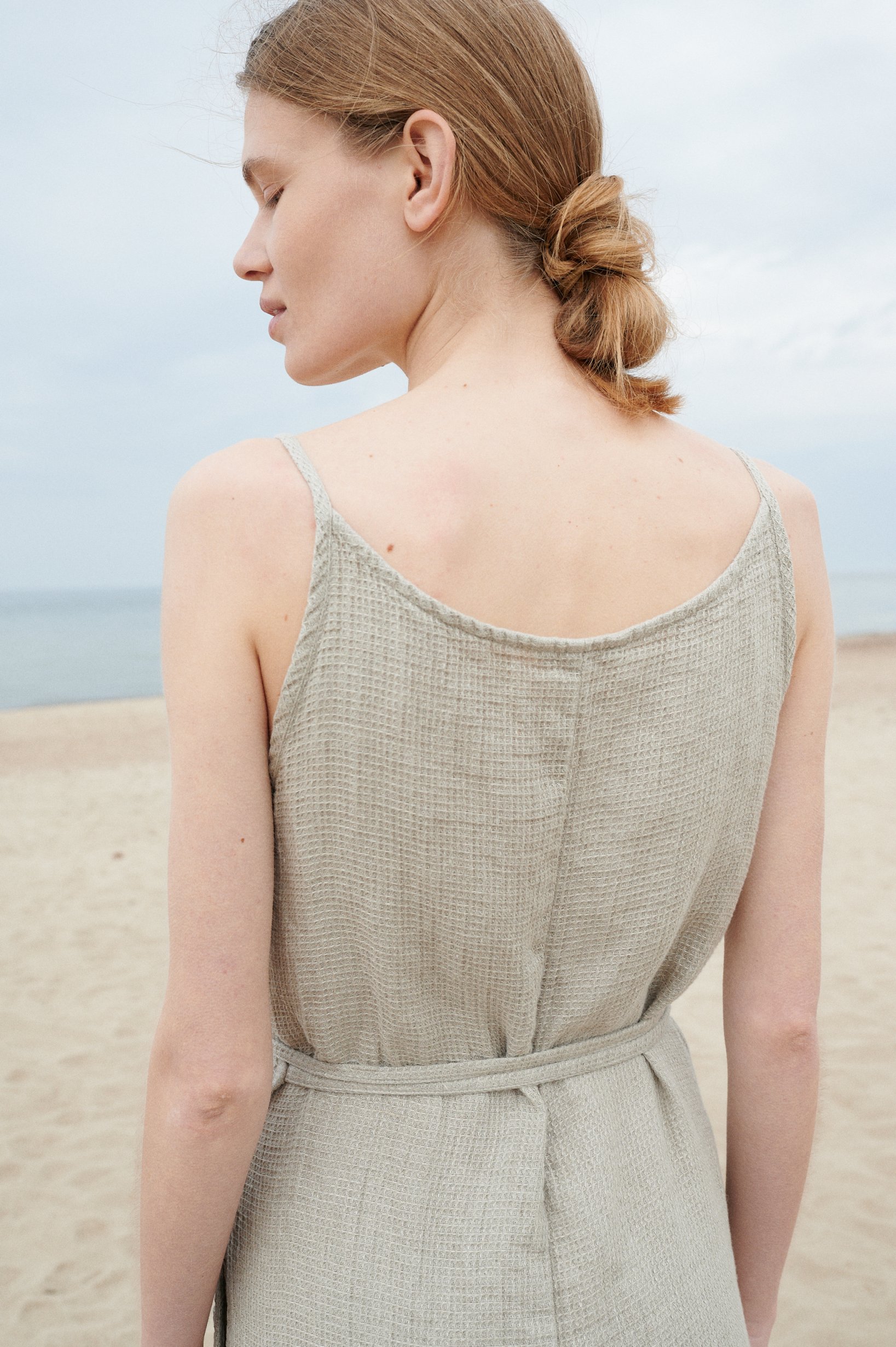 Back of a natural grey waffle linen sleeveless dress