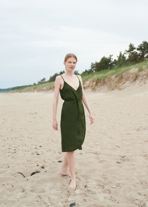 Linenfox model in a waffle-like textured linen summer dress with thin straps and a matching belt
