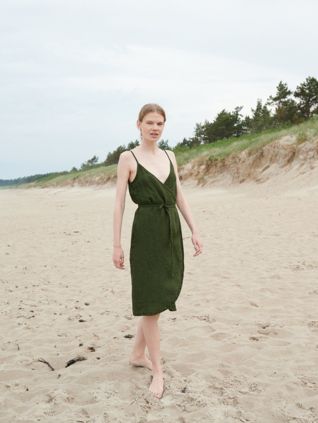 Linenfox model in a waffle-like textured linen summer dress with thin straps and a matching belt