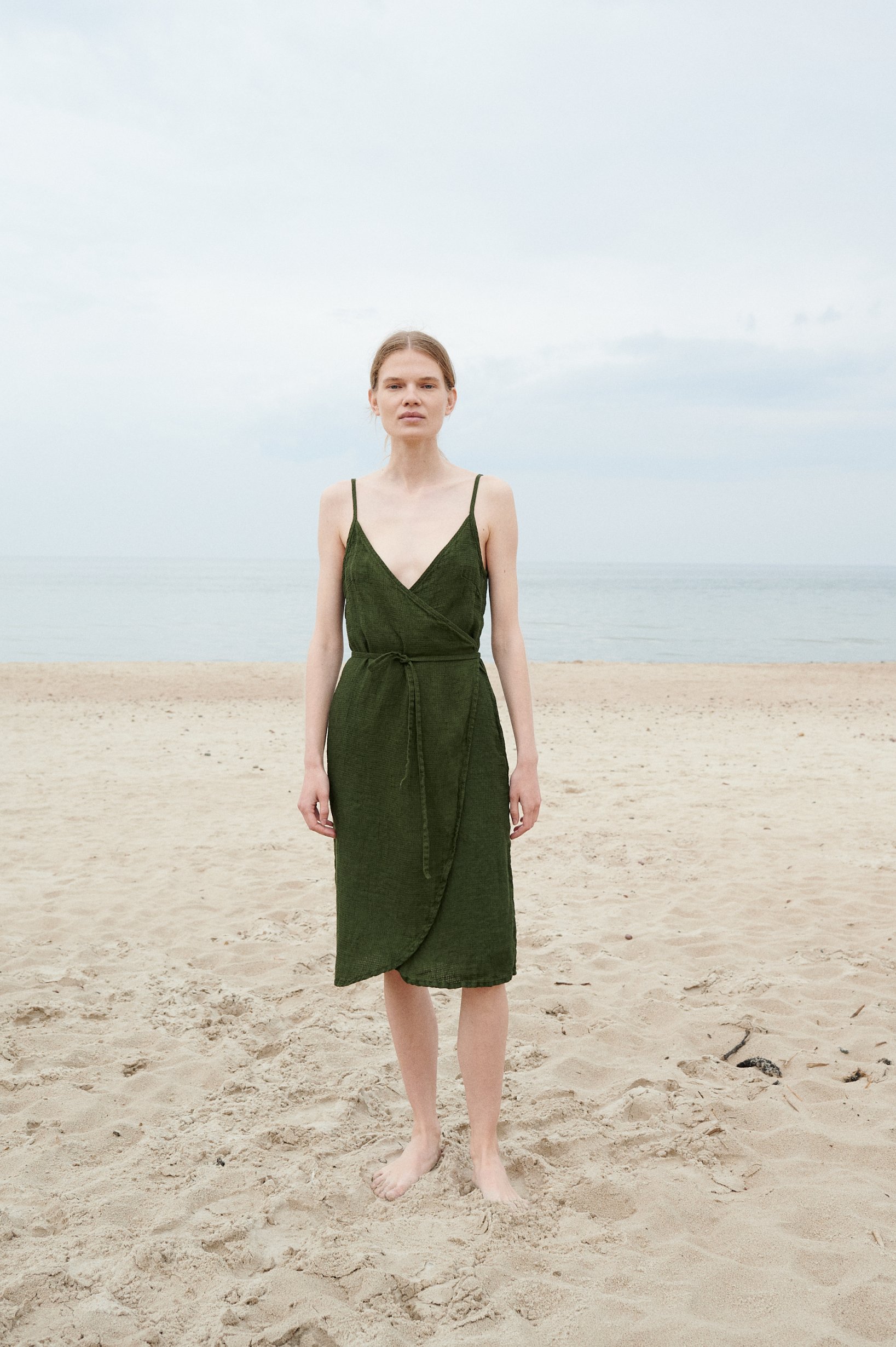 A forest green waffle linen midi dress with thin straps