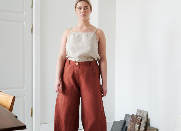 A woman in brown high waisted heavy linen pants