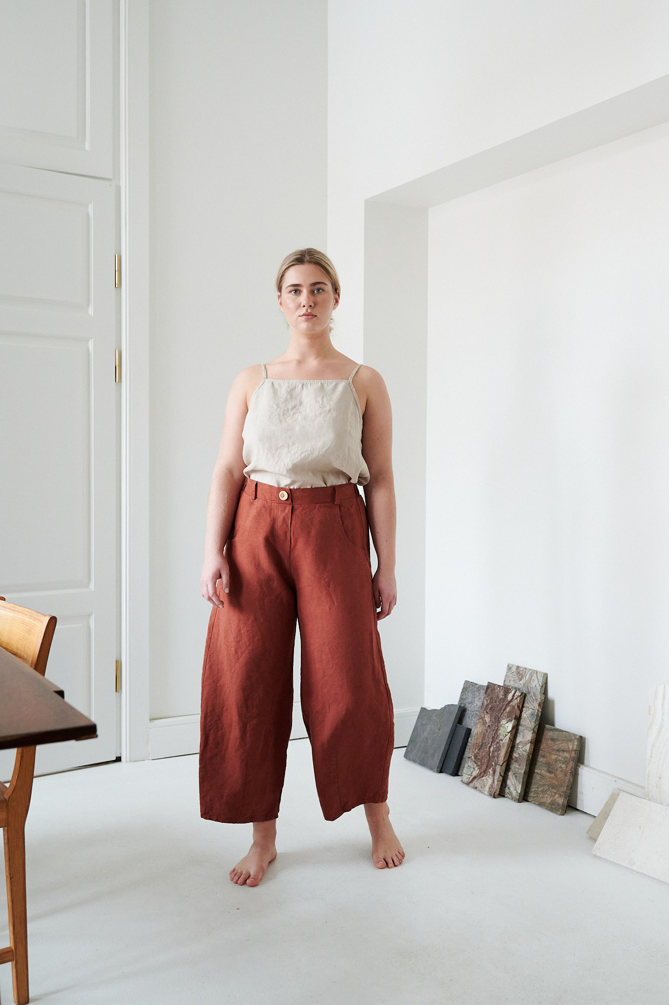 A woman in brown high waisted heavy linen pants