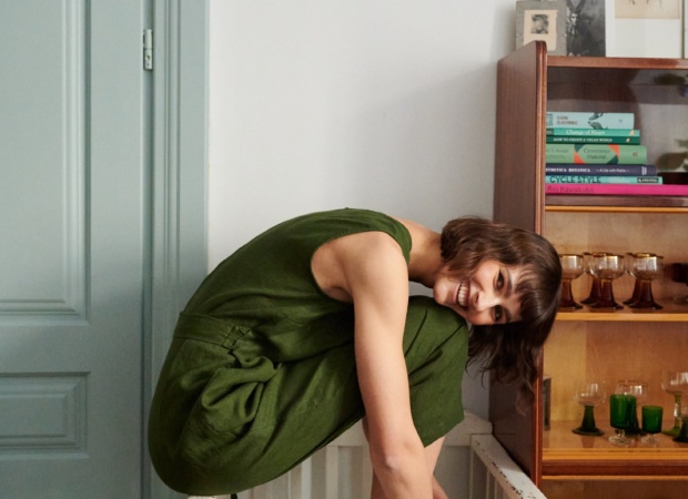 Woman in a forest green sleeveless linen jumpsuit