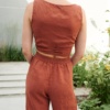 Back of a cropped wrap linen top paired with high-waisted linen pants