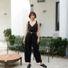 A woman standing in black high waisted pants from heavy linen