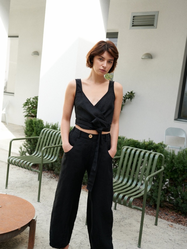 A woman wearing heavy linen black trousers