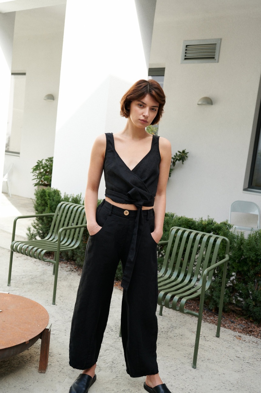 A woman wearing heavy linen black trousers