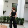 The back of black heavy linen barrel trousers