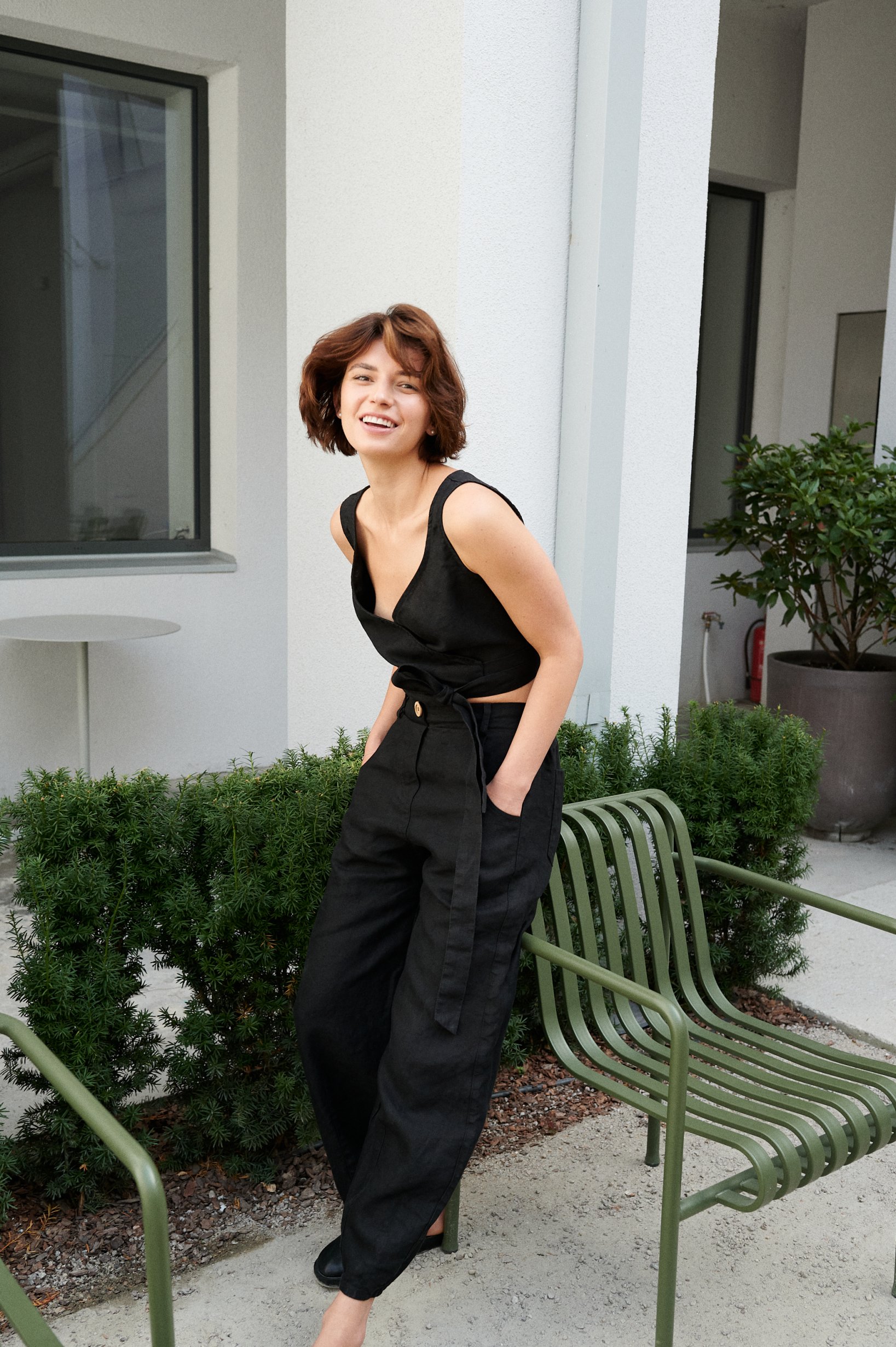 A model wearing heavy linen black trousers and a matching top