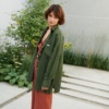 A woman wearing green button down