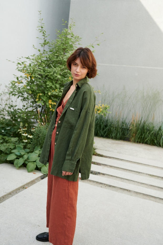 A woman wearing green button down