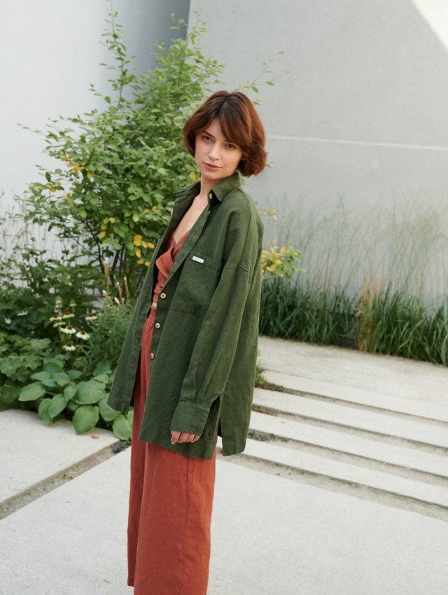 A woman wearing green button down