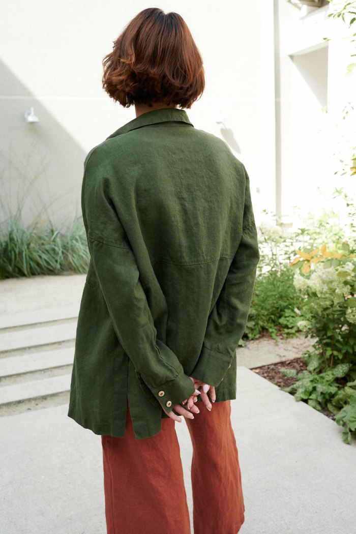 The back of green long hem shirt
