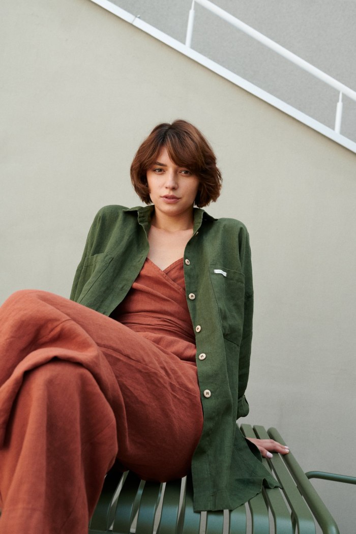 A model wearing green linen shirt