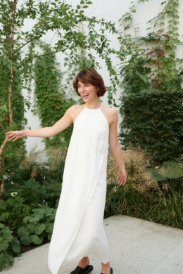 Woman in a long white sleeveless linen dress
